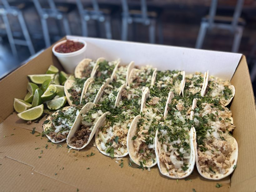 Taco catering tray β cheesesteak tacos with cilantro, onion, lime and salsa