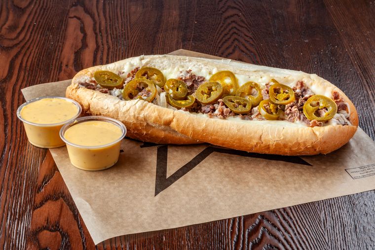 Texican cheesesteak — beef, mozzarella, jalapenos with queso on the side