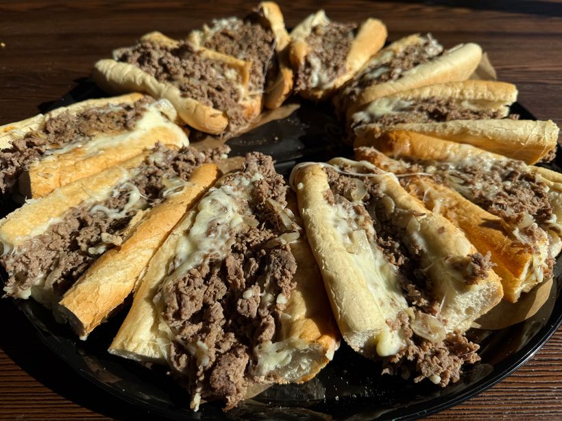 Cheesesteak catering tray β cut cheesesteak sections on a platter, serves 10