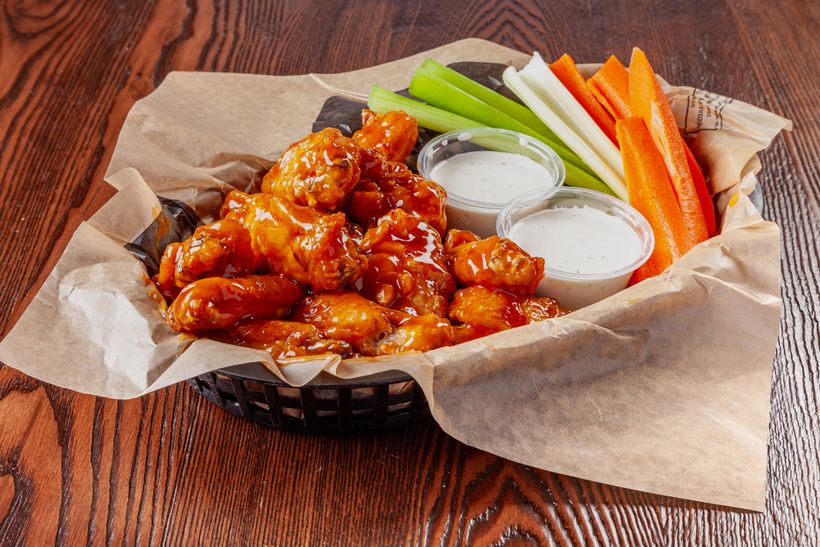 Traditional wings tossed in sauce with celery, carrots and ranch